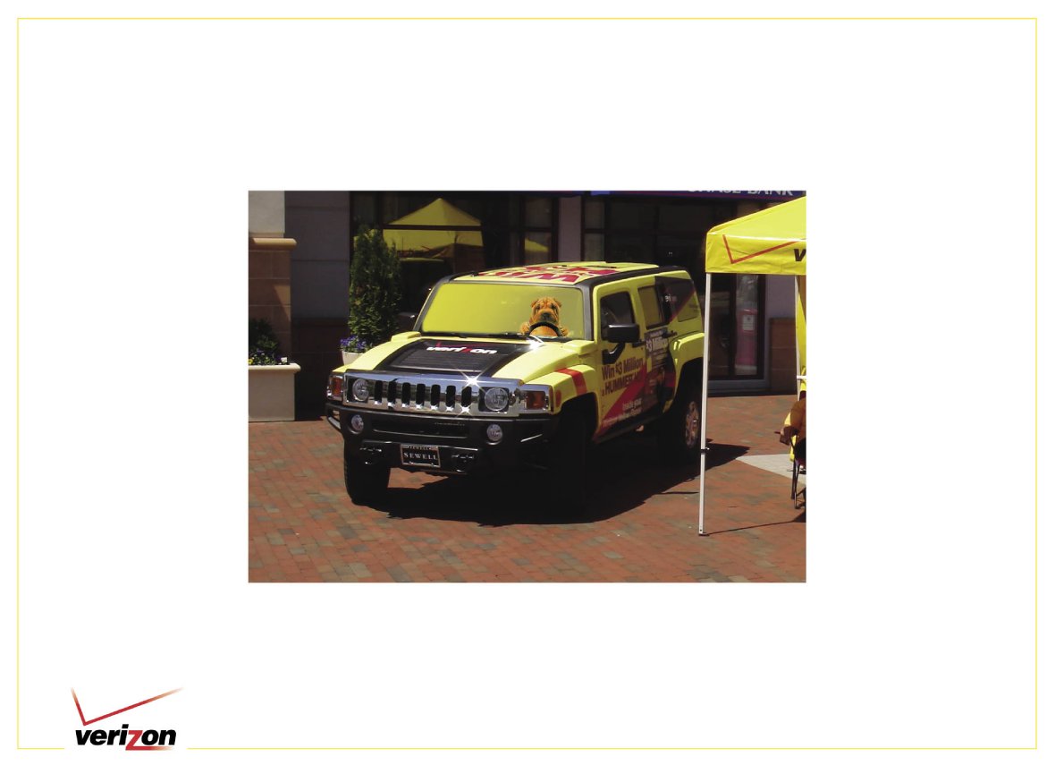Yellow Verizon promotional vehicle beside a branded event tent